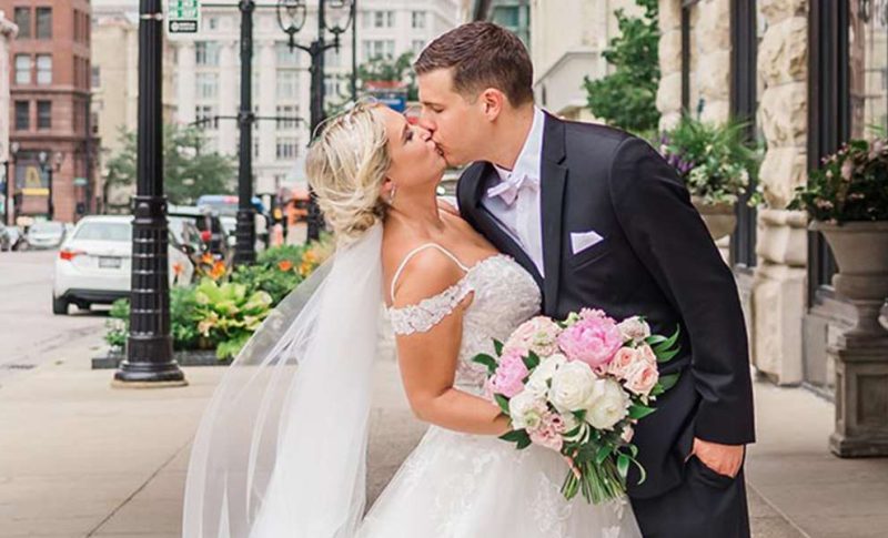 bride and groom sharing a kiss outside the Pfister